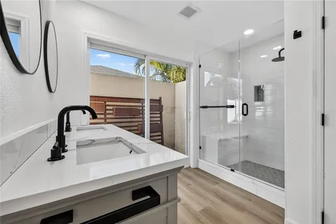 a view of a room with wooden floor and a refrigerator