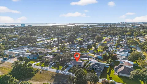 an aerial view of residential building with outdoor space and lake view in back