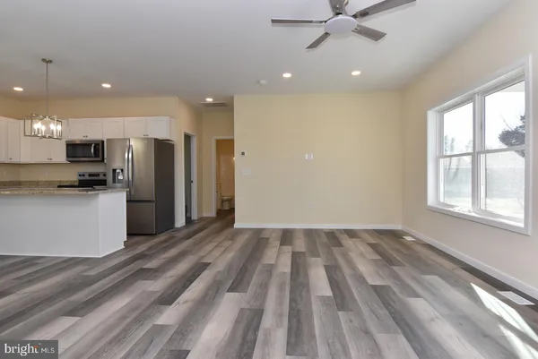 a view of kitchen with stove and refrigerator