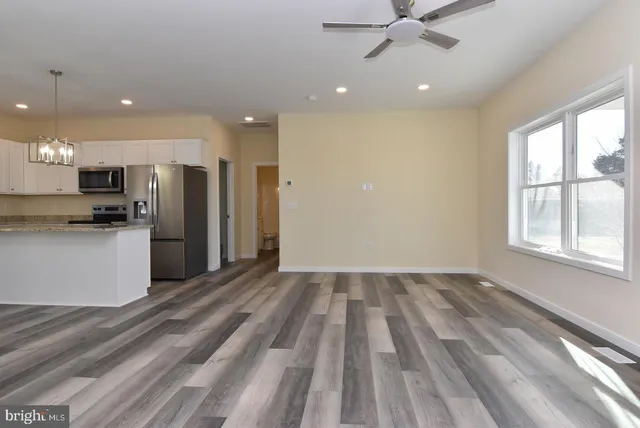 a view of kitchen with stove and refrigerator