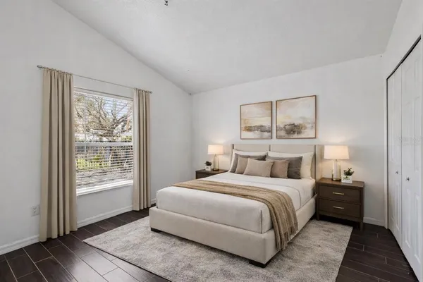 a bedroom with a large bed and a window