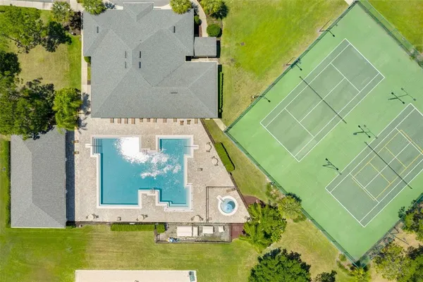 an aerial view of a house with a yard