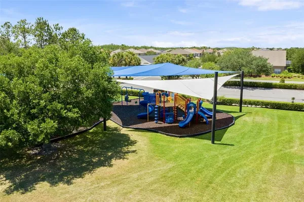 a view of a swimming pool with a patio and a garden