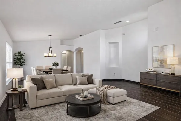 a living room with furniture and wooden floor