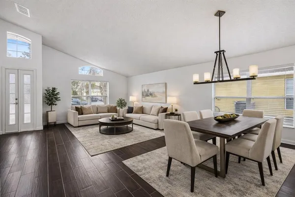 a living room with furniture a window and a table