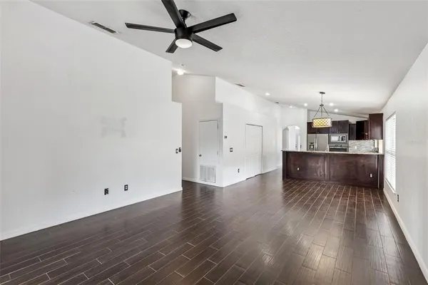a view of a kitchen with a sink and wooden floor