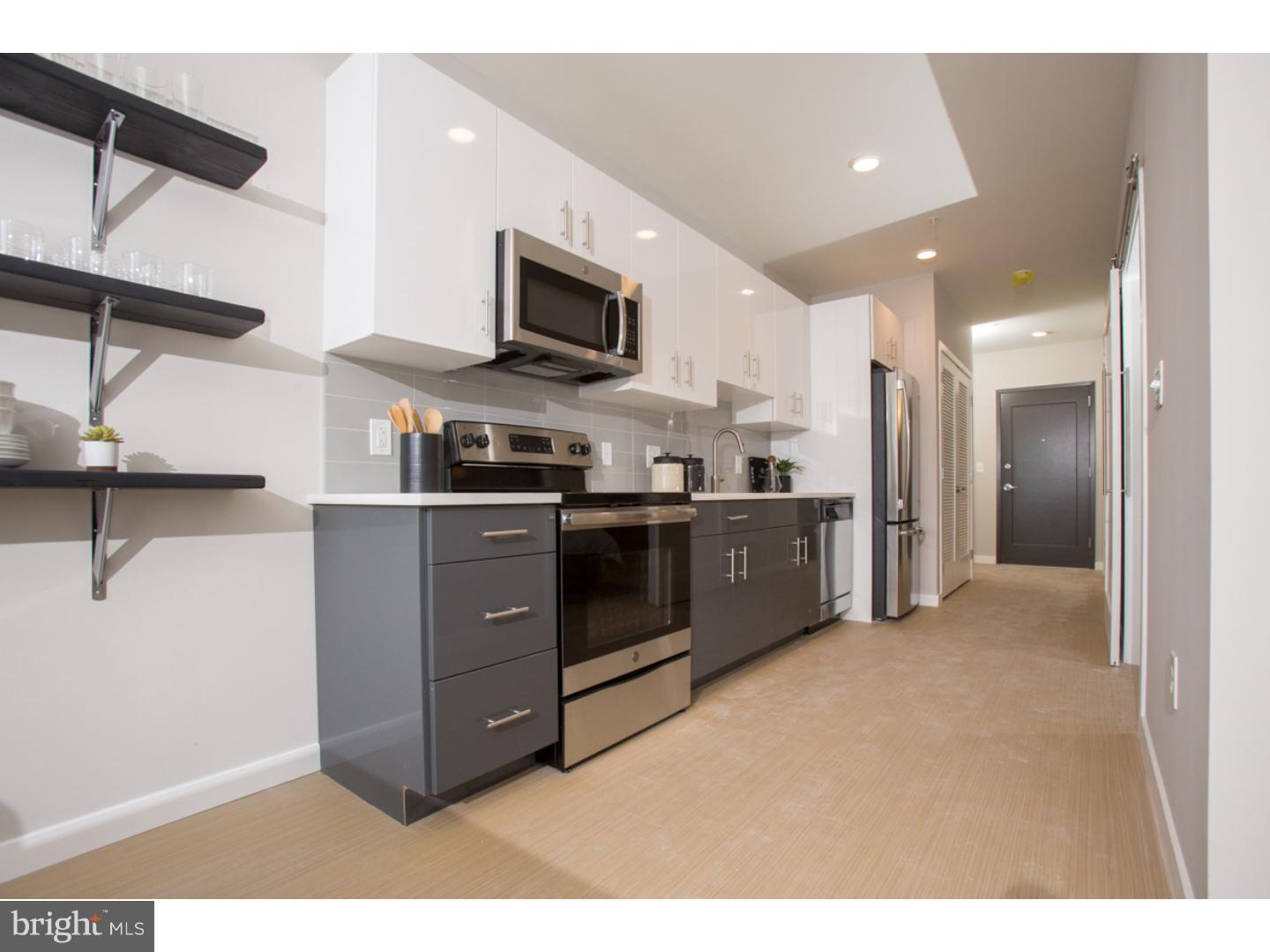 121 North 2nd Street, Unit 601 Philadelphia, PA 19106 - Photo 6 of 17 a kitchen with stainless steel appliances kitchen island granite countertop a refrigerator and a sink