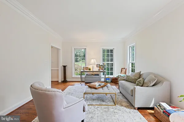 a living room with furniture and a book shelf