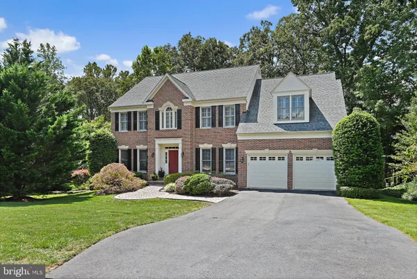 a kitchen with stainless steel appliances granite countertop a stove refrigerator and cabinets