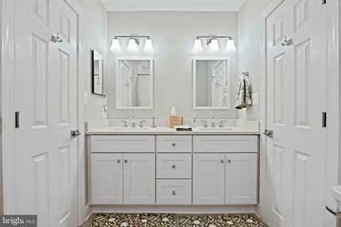 a view of a kitchen with kitchen island a dining table chairs appliances and cabinets