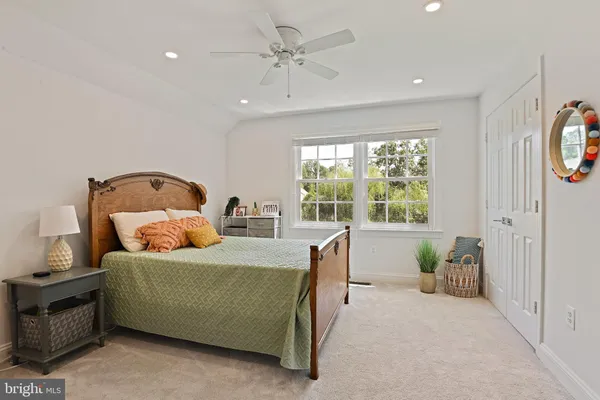 a bedroom with a bed and a book shelf