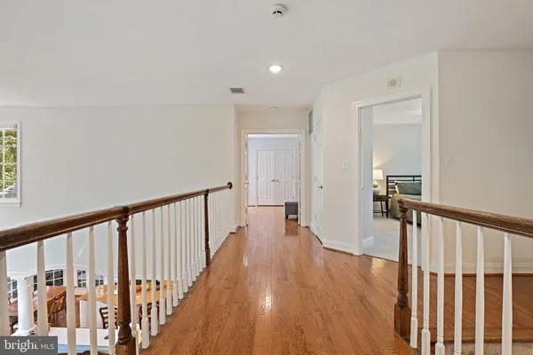 a view of a balcony with wooden floor and outdoor seating