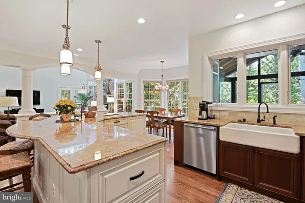 a kitchen with stainless steel appliances granite countertop a sink stove and cabinets