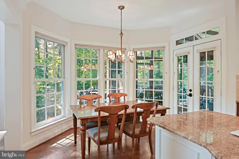 a large kitchen with kitchen island a counter space a sink stainless steel appliances and cabinets