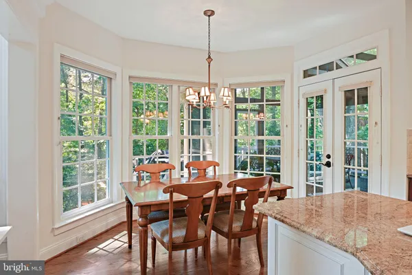 a large kitchen with kitchen island a counter space a sink stainless steel appliances and cabinets
