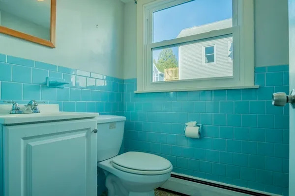 a bathroom with a sink a toilet and a mirror