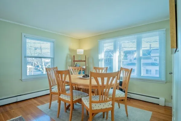 a view of a dining room with furniture and wooden floor