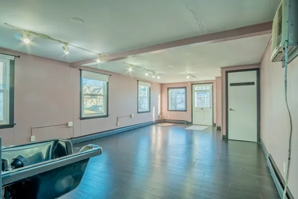 a view of an entryway with wooden floor and windows