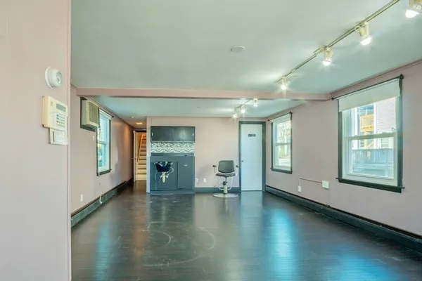 a view of a room with chairs and rug