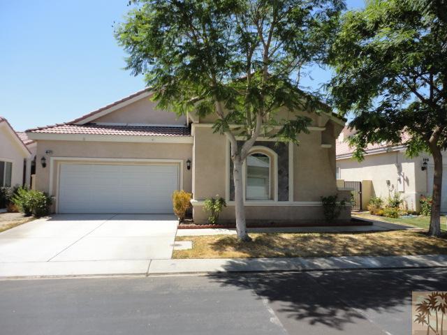 49473 Wayne Street Indio, CA 92201 - Photo 1 of 20 a front view of a house with a yard and garage