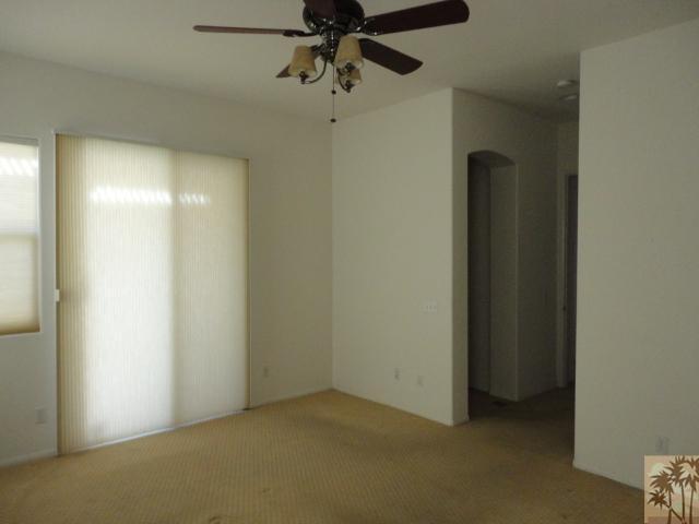 49473 Wayne Street Indio, CA 92201 - Photo 12 of 20 an empty room with a ceiling fan and carpet