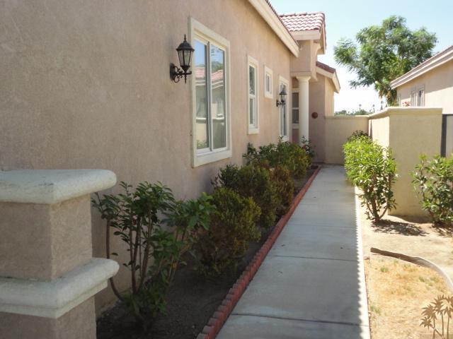 49473 Wayne Street Indio, CA 92201 - Photo 2 of 20 a view of a pathway with house on both side