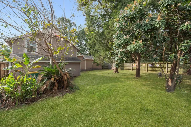 a view of backyard of house with green space