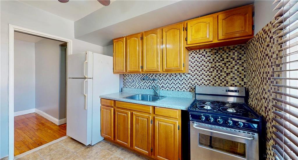 2909 Ocean Avenue, Unit 4E Brooklyn, NY 11235 - Photo 1 of 10 a kitchen with a stove and a refrigerator