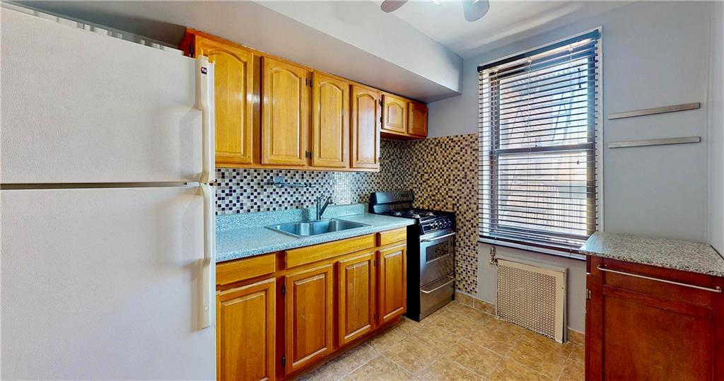 2909 Ocean Avenue, Unit 4E Brooklyn, NY 11235 - Photo 2 of 10 a kitchen with a sink and a stove top oven