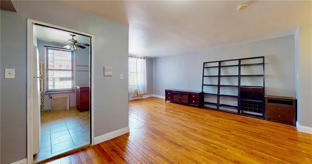 2909 Ocean Avenue, Unit 4E Brooklyn, NY 11235 - Photo 4 of 10 a living room with furniture and a wooden floor