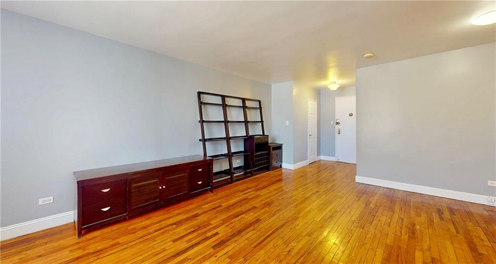 2909 Ocean Avenue, Unit 4E Brooklyn, NY 11235 - Photo 6 of 10 a spacious bedroom with a bed and a wooden floor