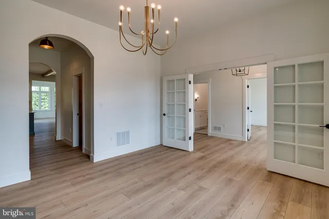 a view of wooden floor and windows in a room