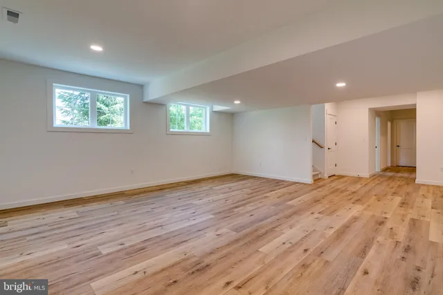 a view of kitchen with kitchen island and stainless steel appliances