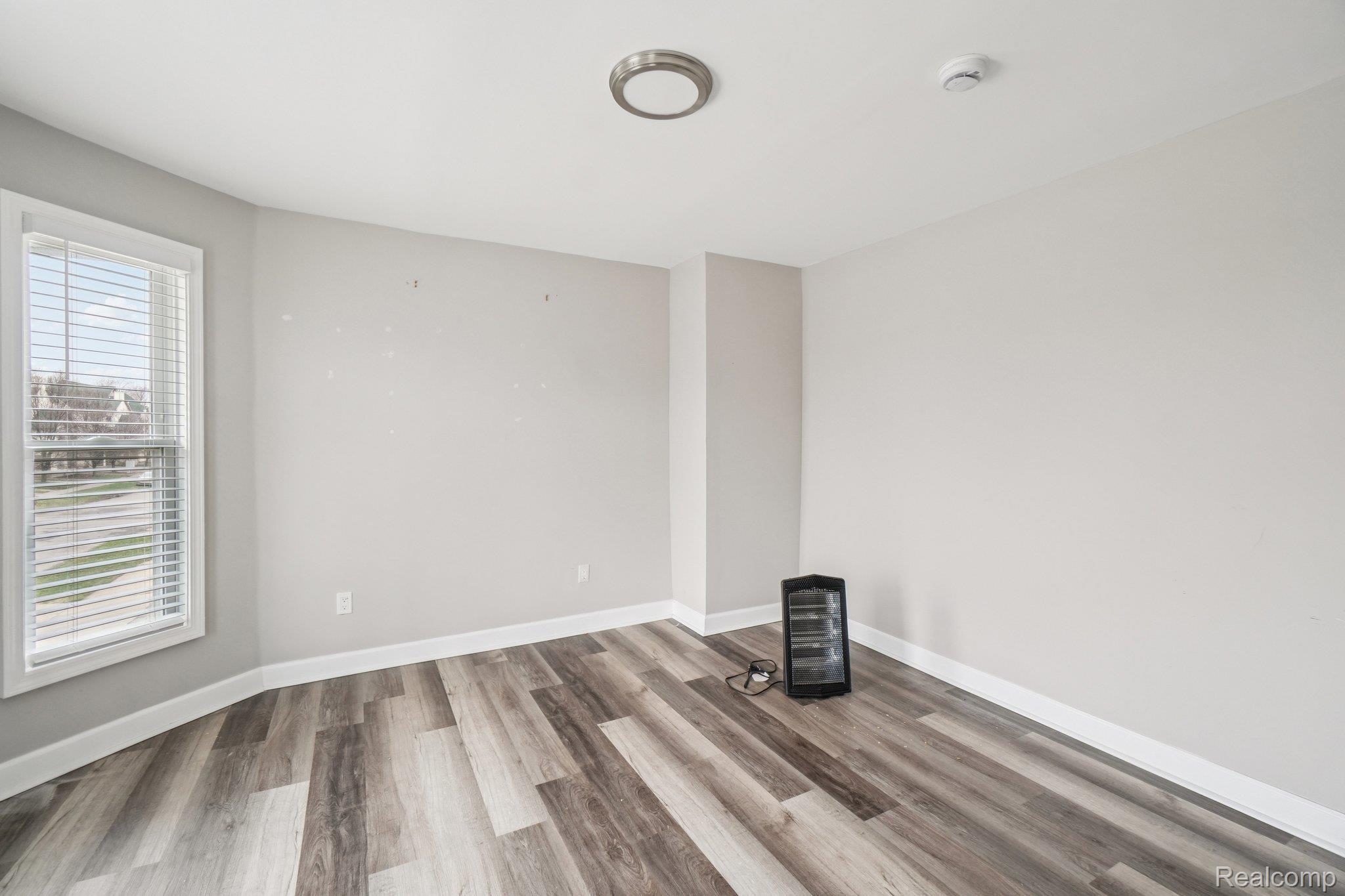 3822 Wabash Street Detroit, MI 48208 - Photo 6 of 17 Spare room featuring light wood-style floors and baseboards