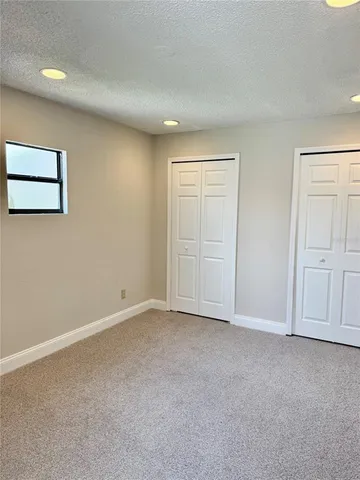 a kitchen with granite countertop a sink a counter top space stainless steel appliances and cabinets
