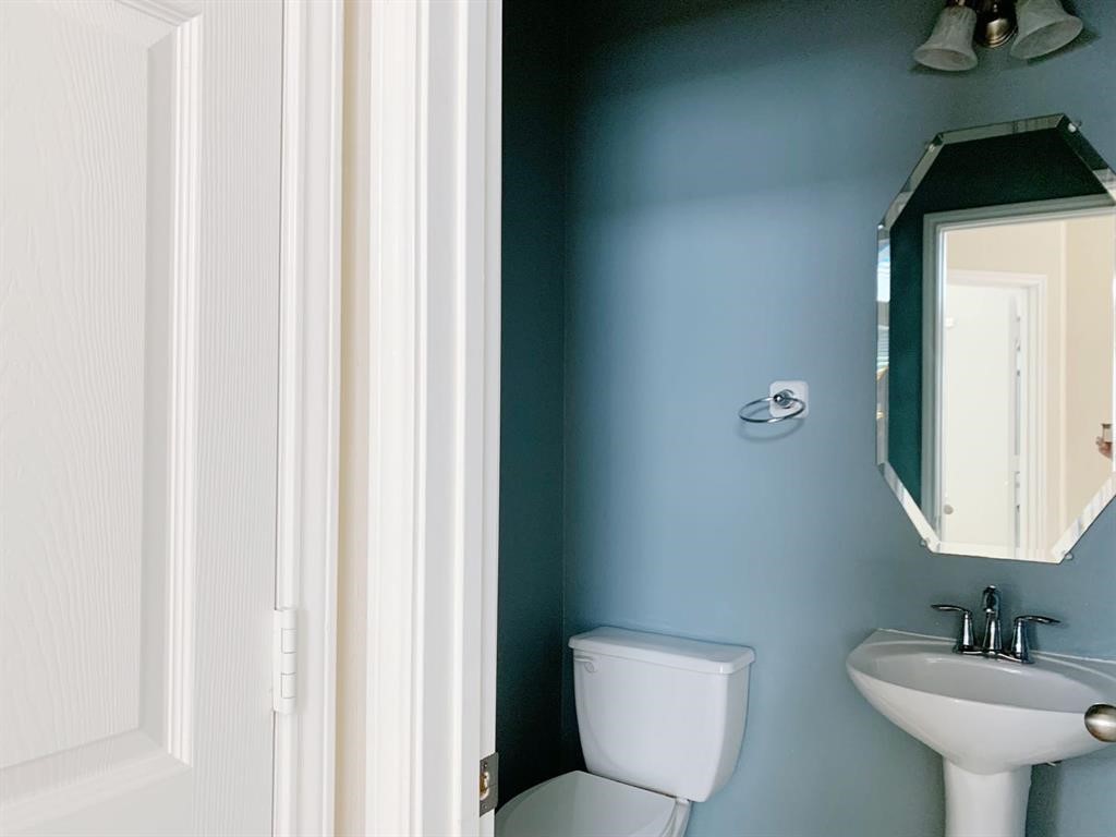 24418 Ranchwood Springs Lane Katy, TX 77494 - Photo 20 of 29 a bathroom with a toilet a sink and mirror