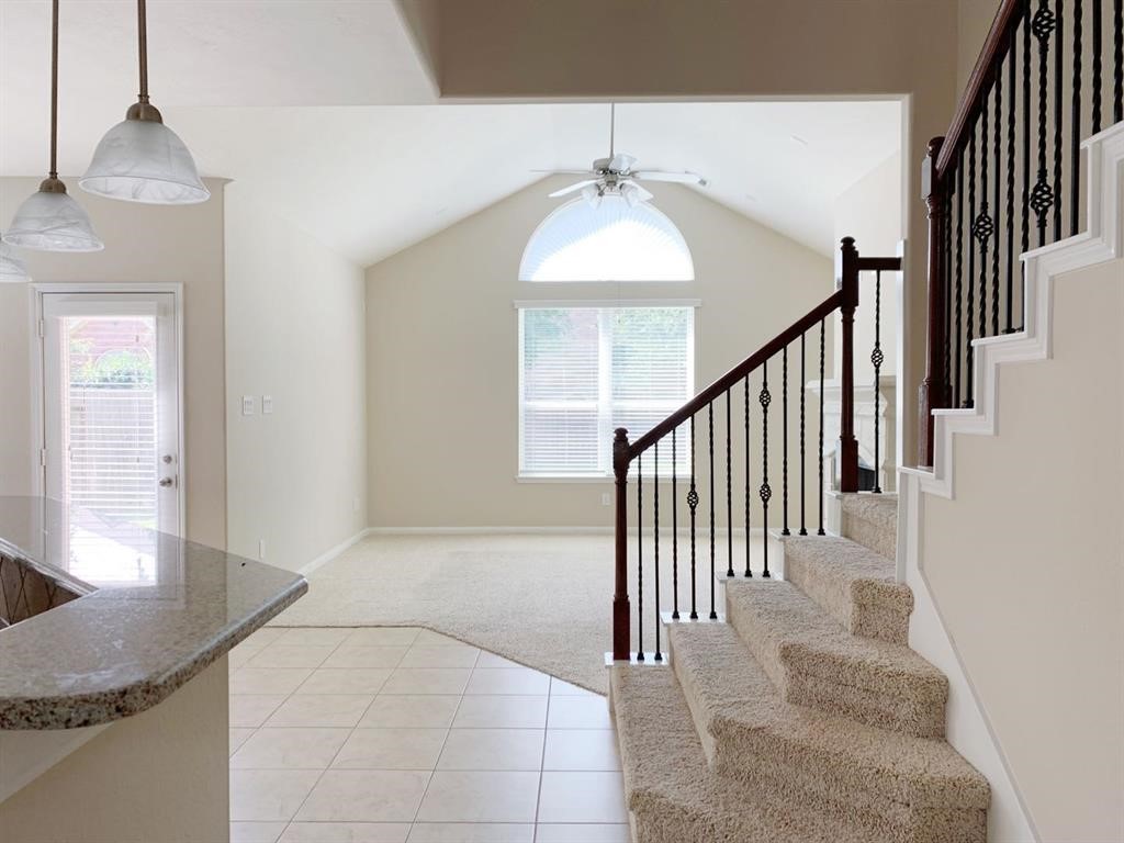 24418 Ranchwood Springs Lane Katy, TX 77494 - Photo 6 of 29 a view of staircase with railing and a chandelier