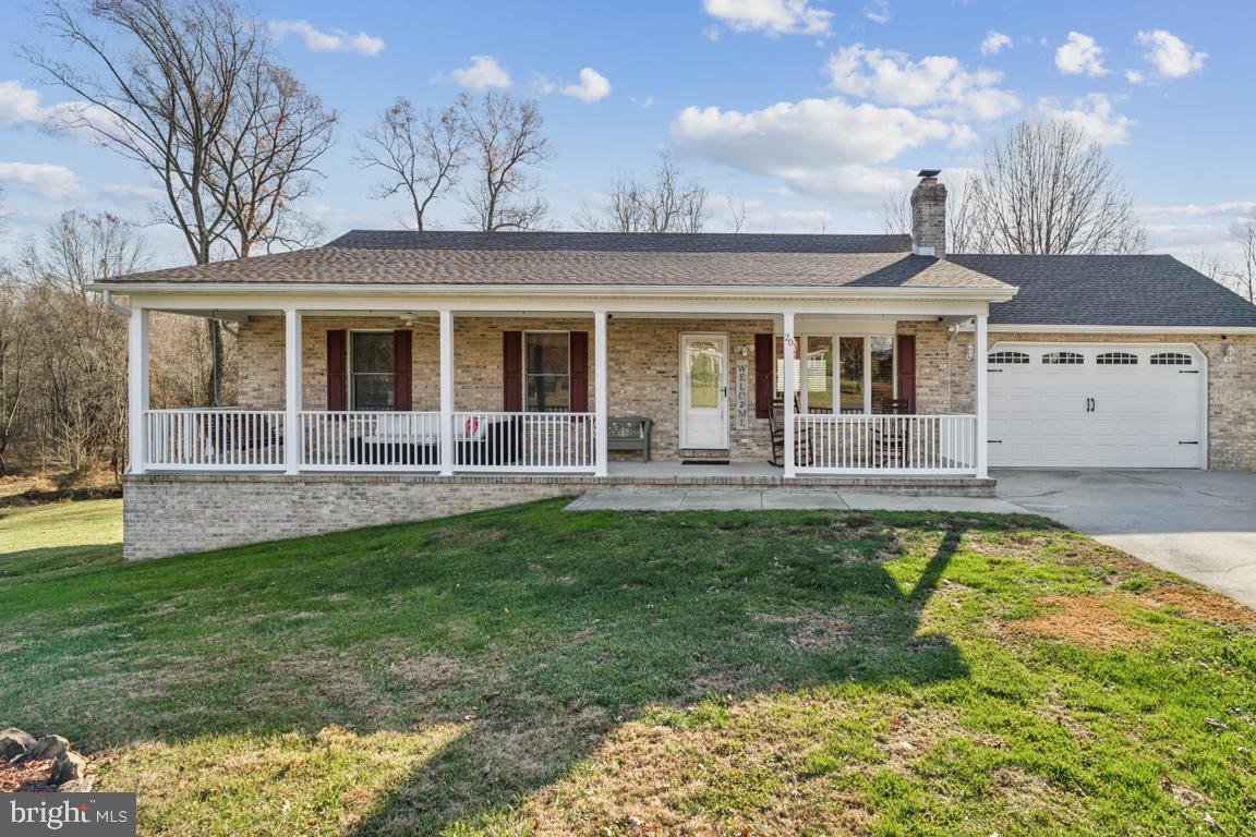 a front view of a house with a yard table and chairs
