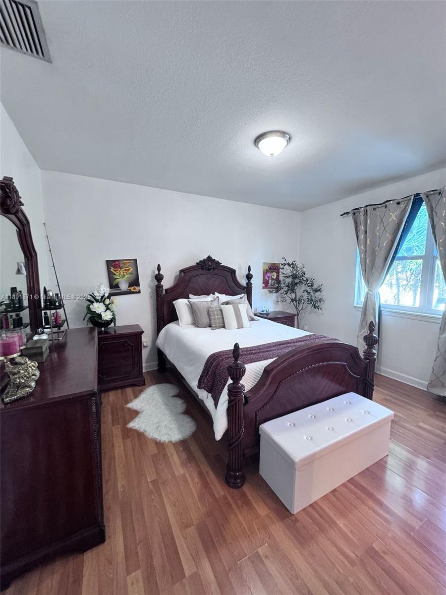 11041 Southwest 246th Street Homestead, FL 33032 - Photo 12 of 25 a bedroom with a bed and window