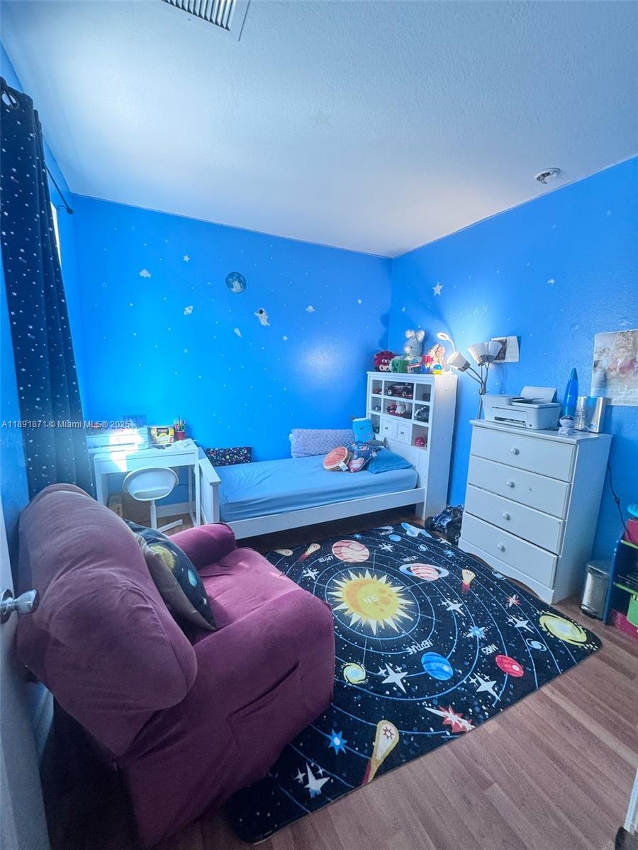 11041 Southwest 246th Street Homestead, FL 33032 - Photo 20 of 25 a bed room with bed and a night stand