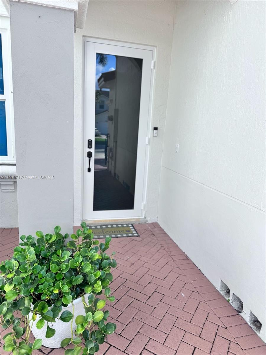 11041 Southwest 246th Street Homestead, FL 33032 - Photo 2 of 25 front view of a house with a yard