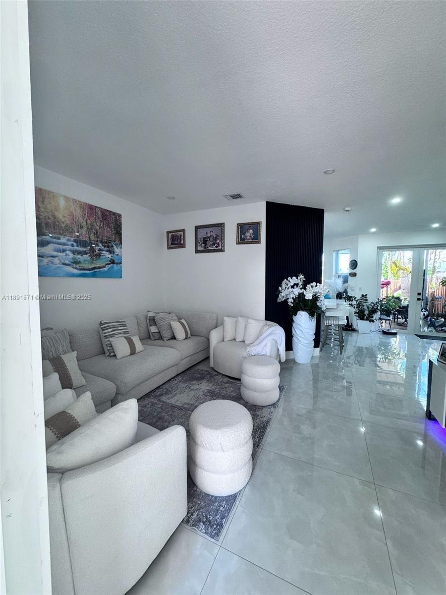 11041 Southwest 246th Street Homestead, FL 33032 - Photo 3 of 25 a living room with furniture and a flat screen tv