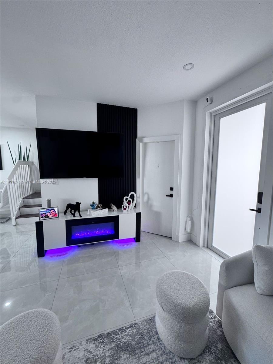 11041 Southwest 246th Street Homestead, FL 33032 - Photo 4 of 25 a living room with furniture and a flat screen tv