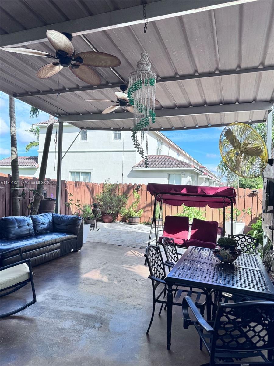 11041 Southwest 246th Street Homestead, FL 33032 - Photo 9 of 25 a patio with a table and chairs
