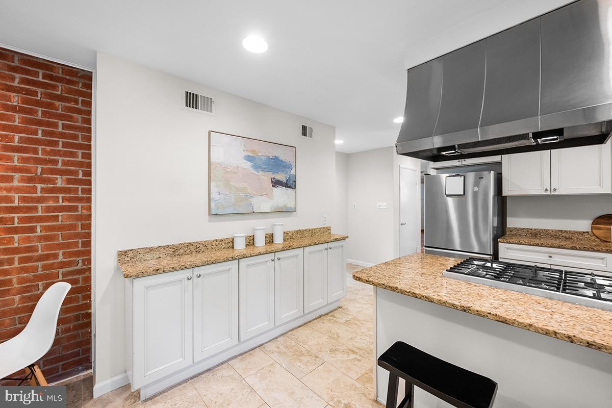 3430 Blair Road Falls Church, VA 22041 - Photo 13 of 40 a kitchen with stainless steel appliances granite countertop a sink stove and cabinets