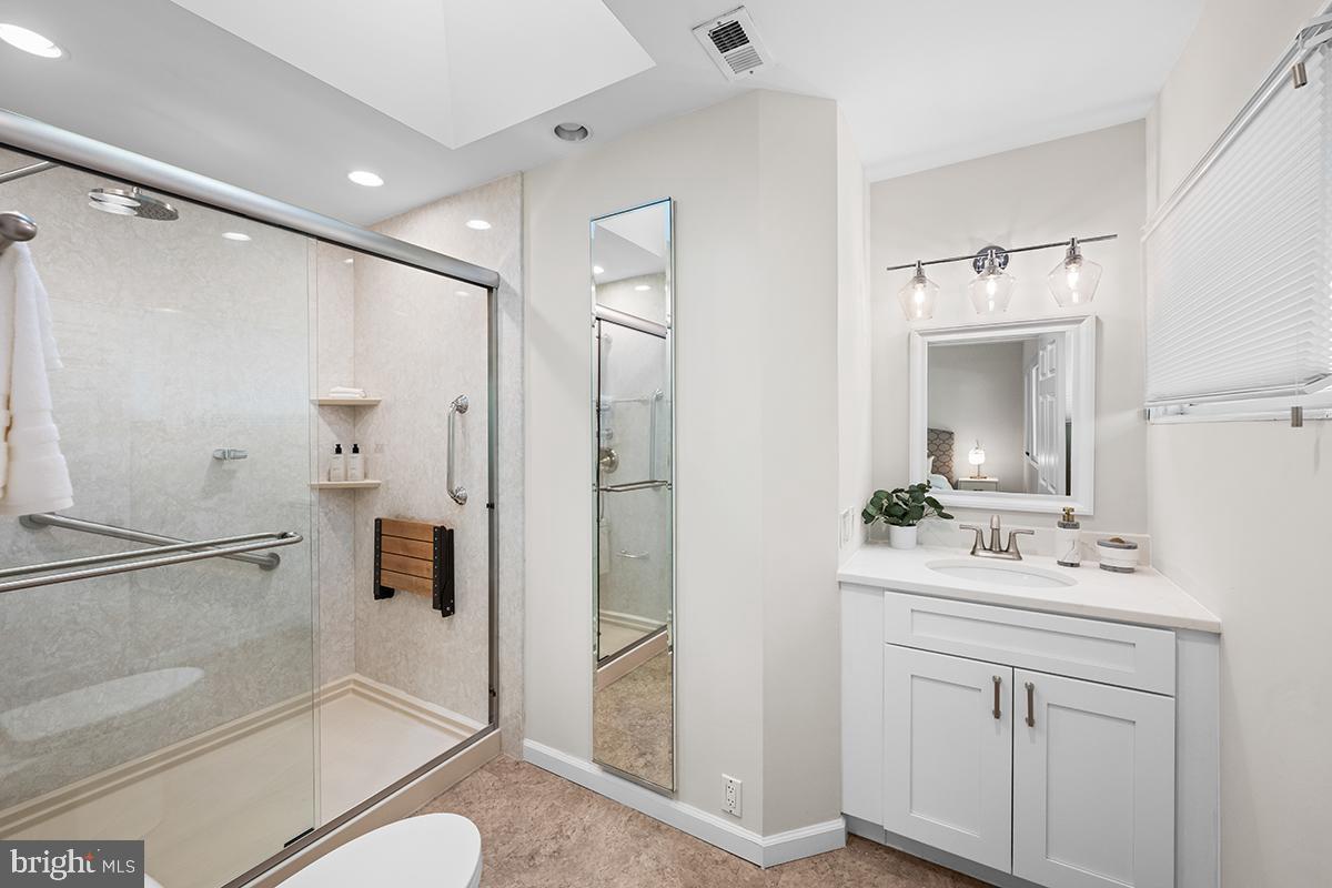 3430 Blair Road Falls Church, VA 22041 - Photo 24 of 40 a bathroom with a sink a toilet a mirror and shower