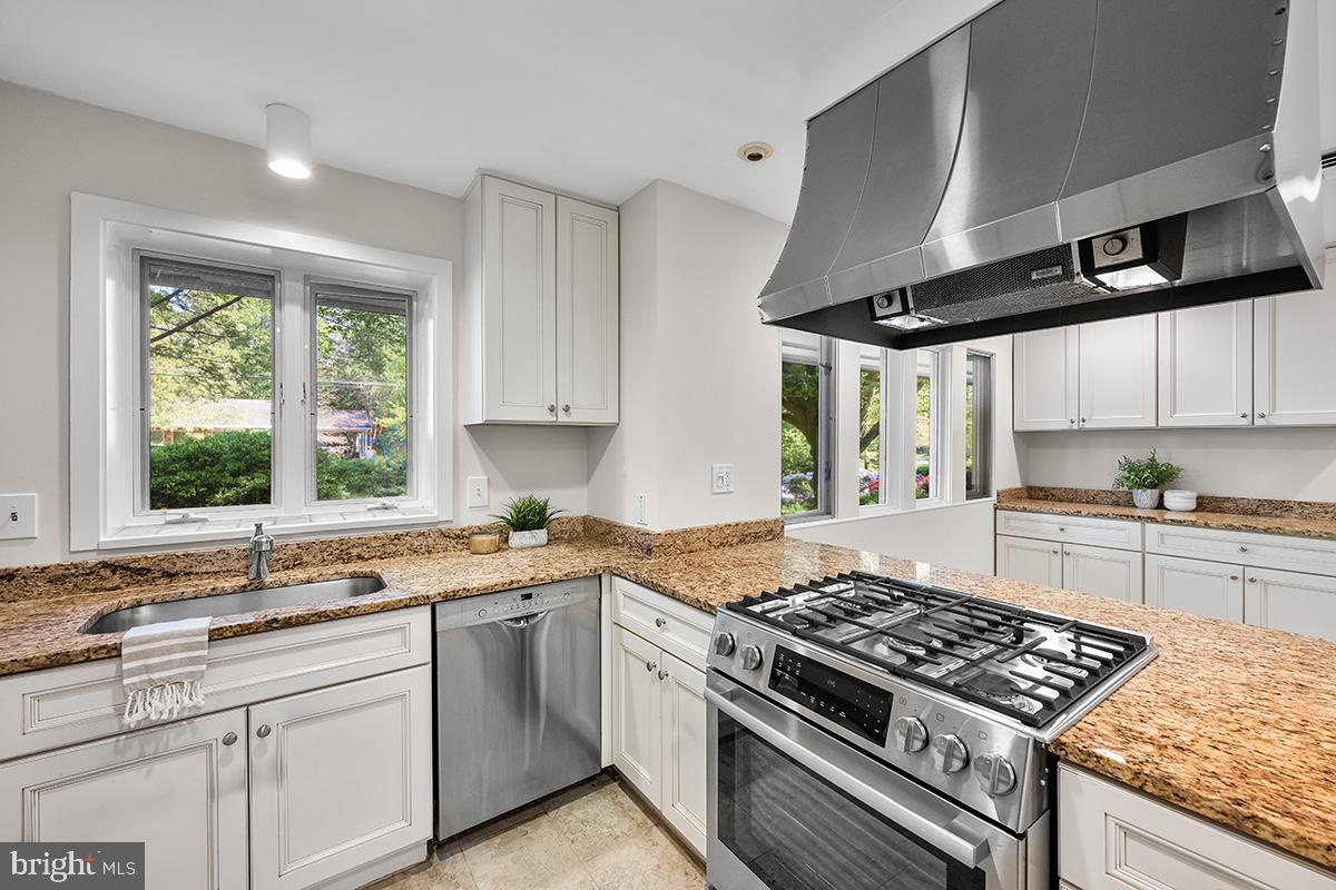 3430 Blair Road Falls Church, VA 22041 - Photo 8 of 40 a kitchen with stainless steel appliances a sink stove and cabinets