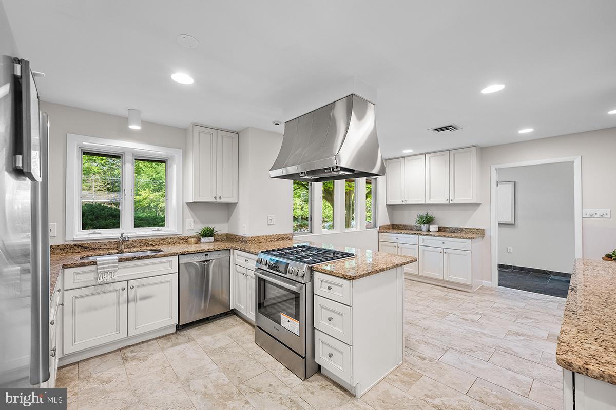 3430 Blair Road Falls Church, VA 22041 - Photo 9 of 40 a kitchen with stainless steel appliances granite countertop a sink stove and refrigerator