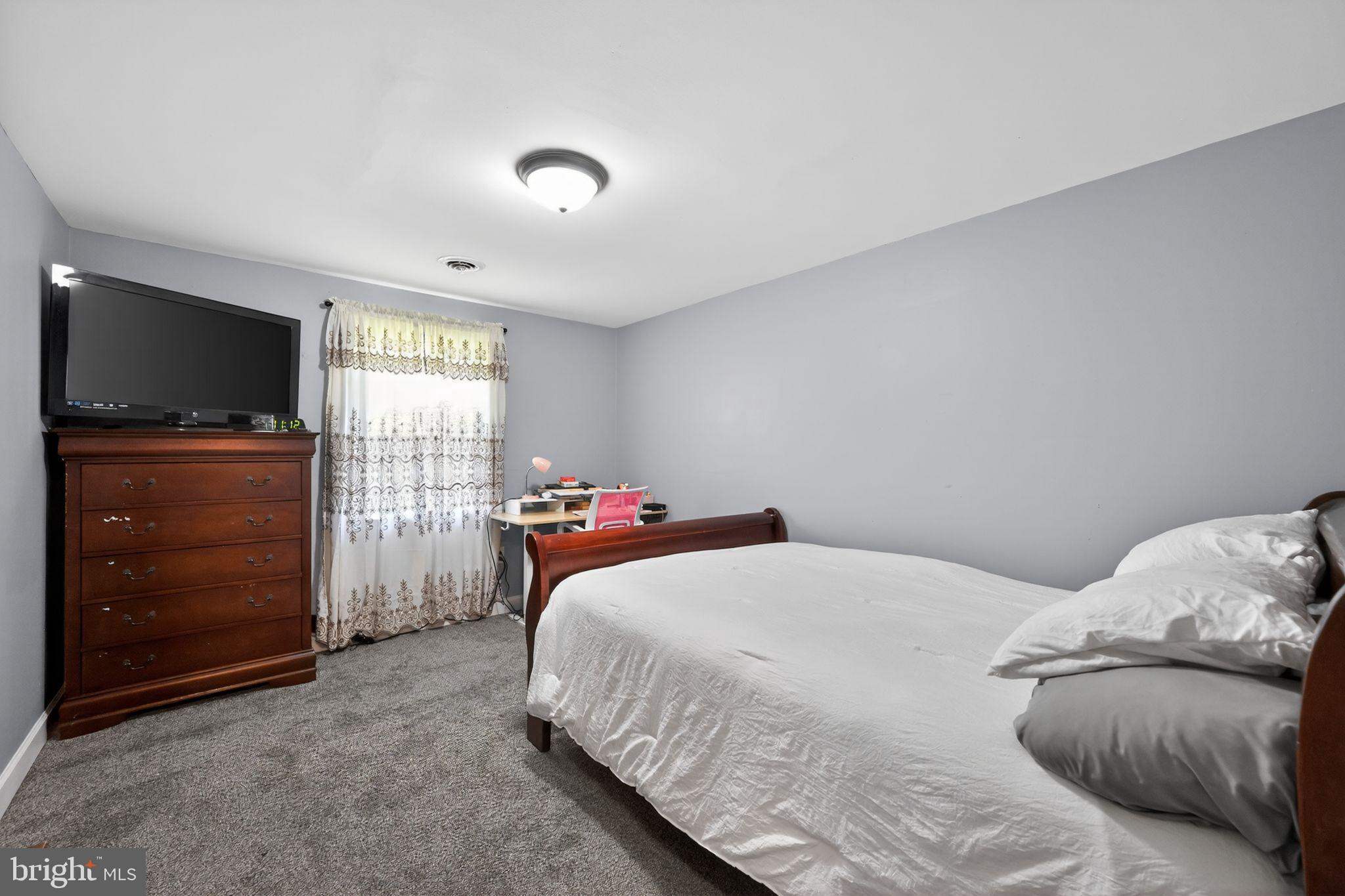 525 Mountain Road Dillsburg, PA 17019 - Photo 24 of 53 a bedroom with a bed and a flat screen tv