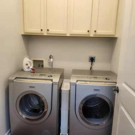a utility room with sink dryer and washer